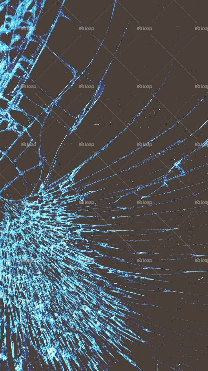 Multi-colored and bright broken smartphone screen close-up.
