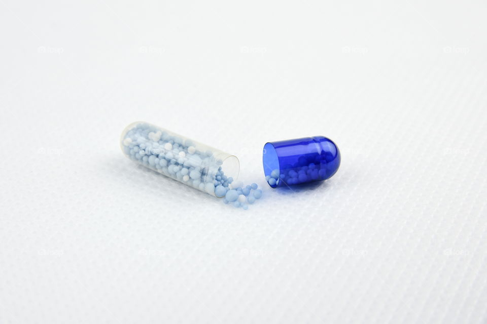 Blue pill on white background