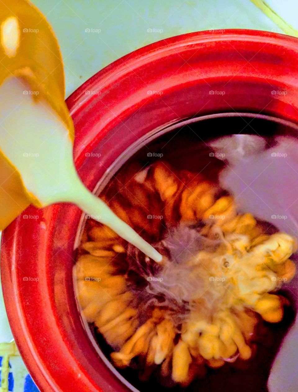 creamer pouring into coffee