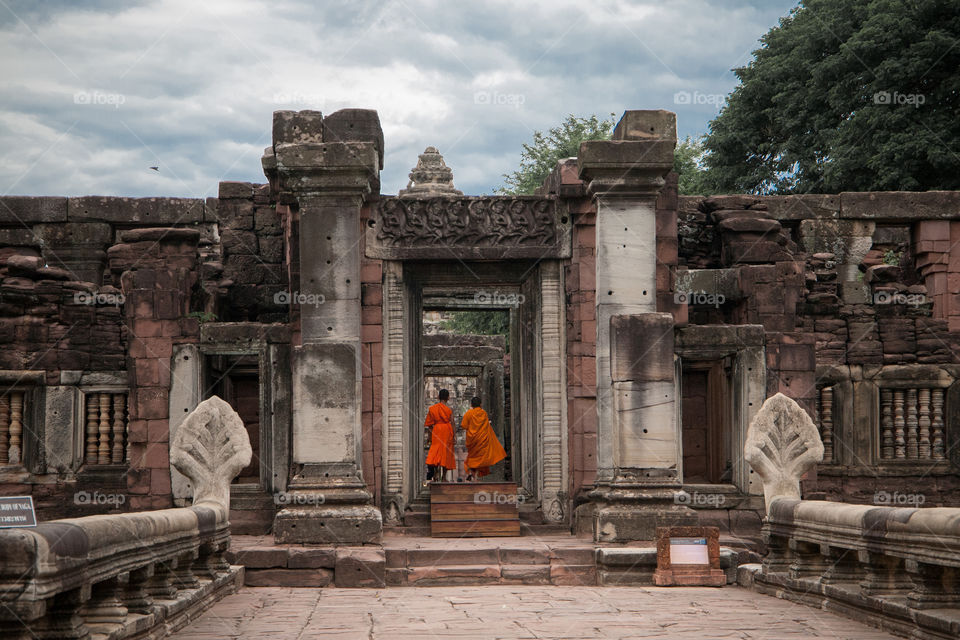 Two monks walking through the ancient door