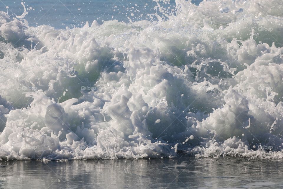 Big wave crashing on the shore making big splash, closeup 