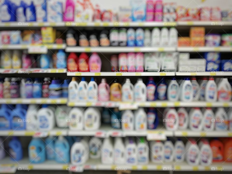 Supermarket shelf full of liquid detergents