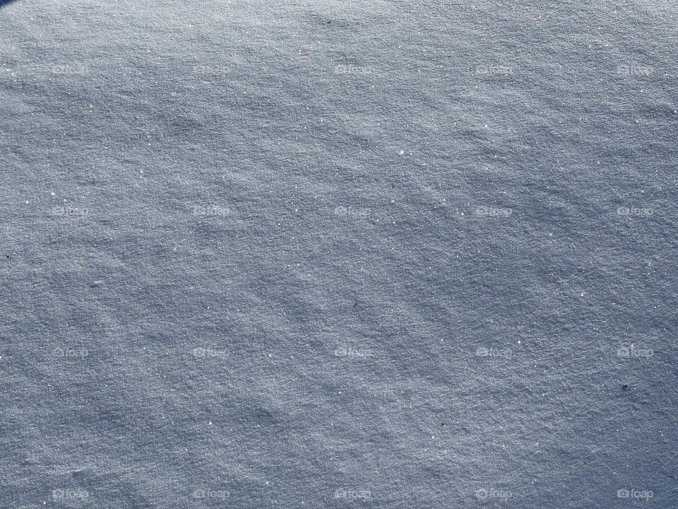 Close up of white shiny snow smooth surface