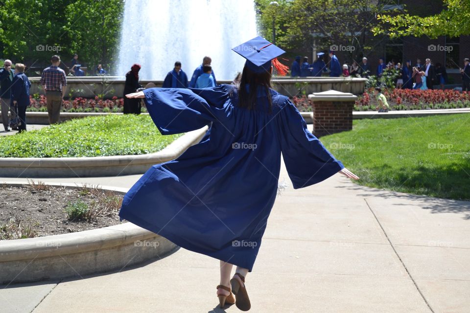 Having fun in a cap in gown before graduation