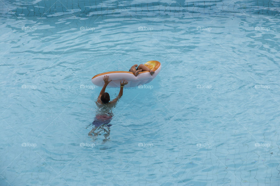 Children playing and enjoying in the pool during summer