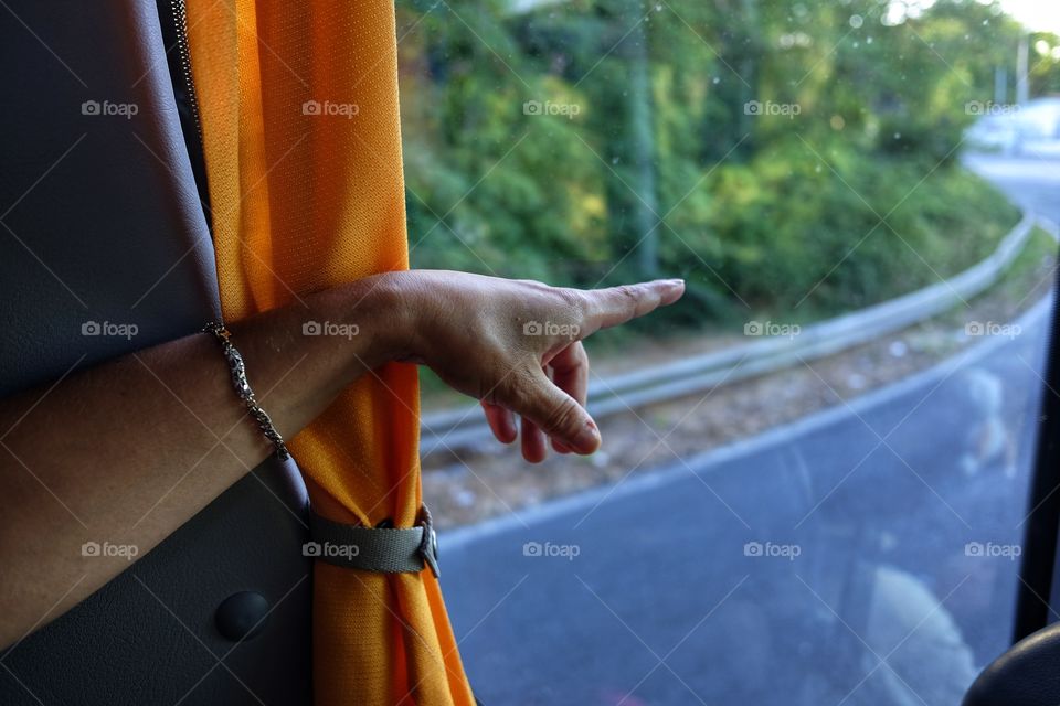 Hand indicates a direction while on the bus