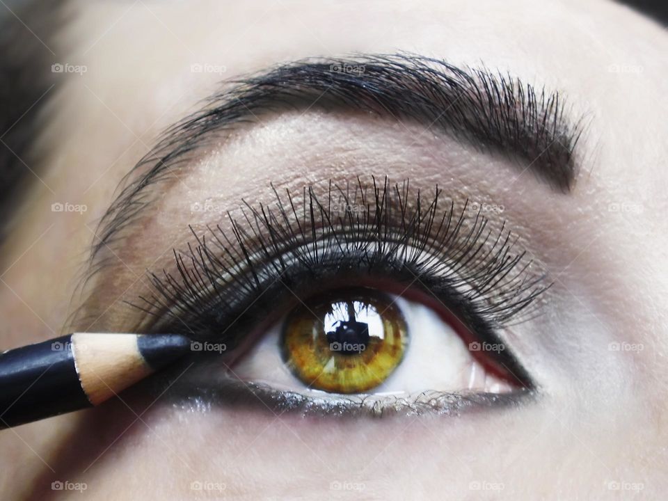 Young woman Applying makeup 