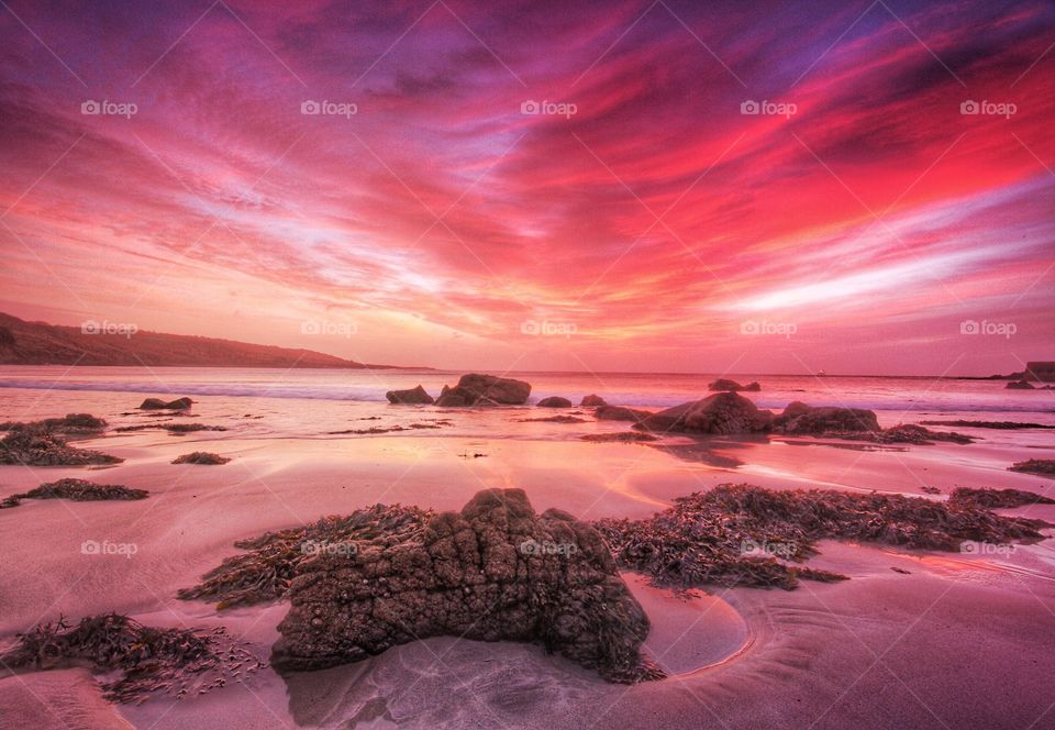 Red Sky In The Morning. An early morning seascape with a foreboding red sky and clouds.