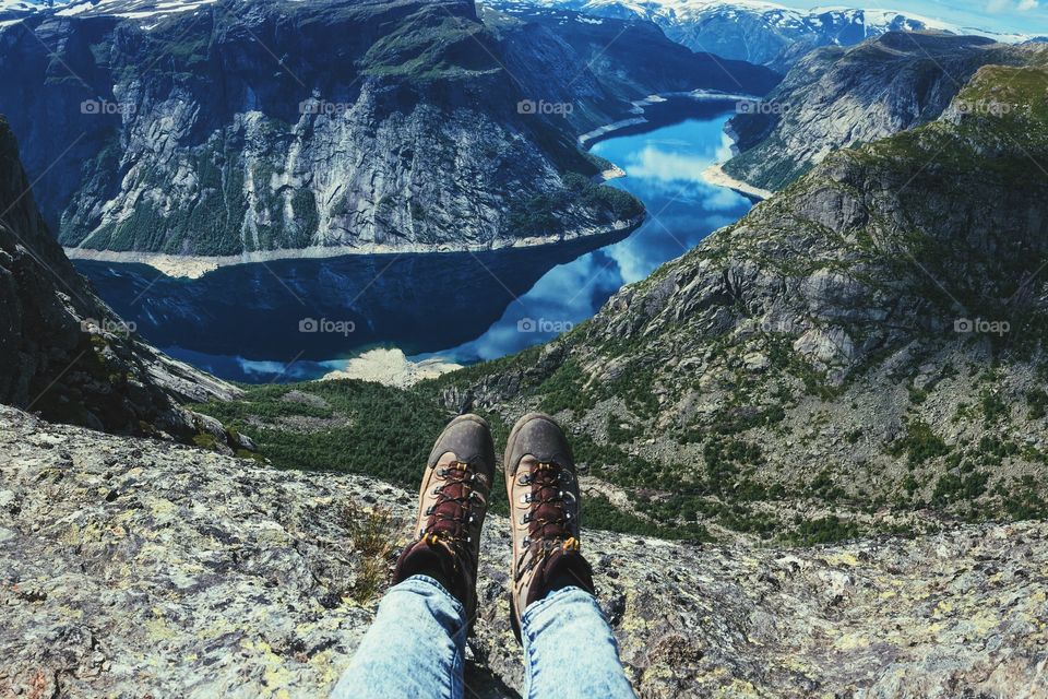 Feet in hiking boots over the fiords 