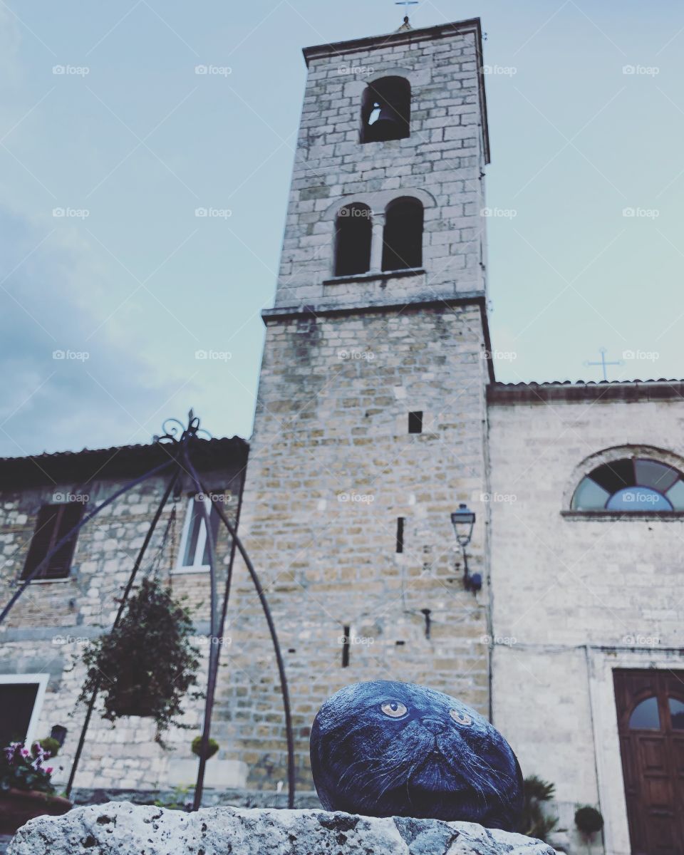 Stone cat under the belfry of the church of Castel Trosino, medieval longobard origin village, Ascoli Piceno County,Marche region, Italy