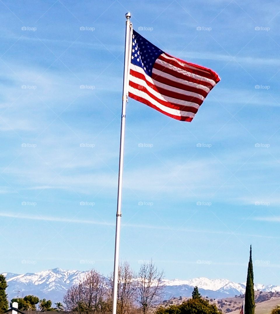 US flag and snowy mountains