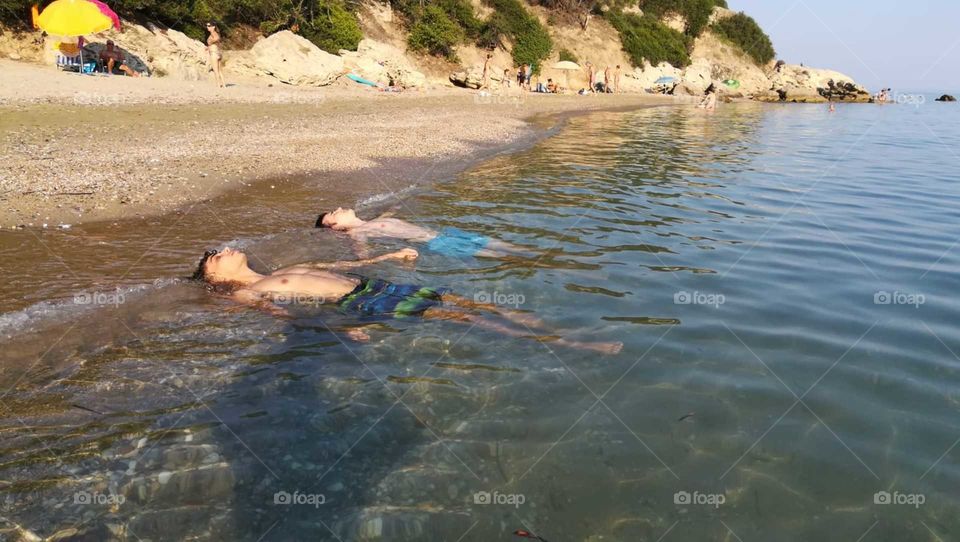 Sunbathing on the beach in the sea