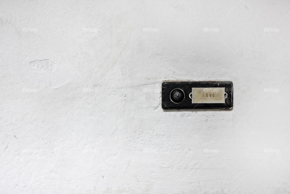 Love doorbell on white wall