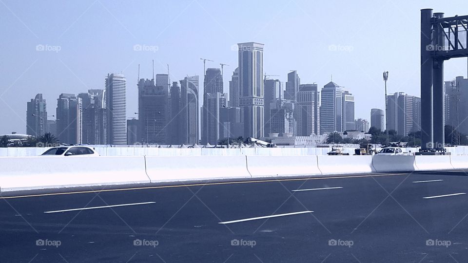 High-rise building visible to the highway/ Blue background