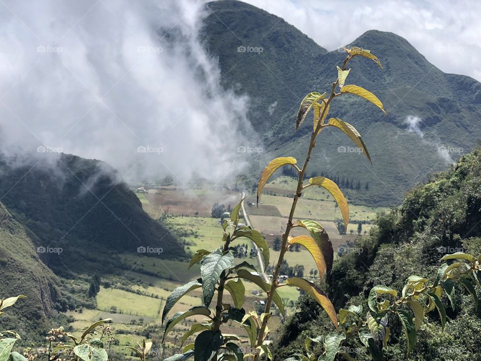Clouds rolling in over mountains in Pululahua Geobotanic Reserve in Ecuador 