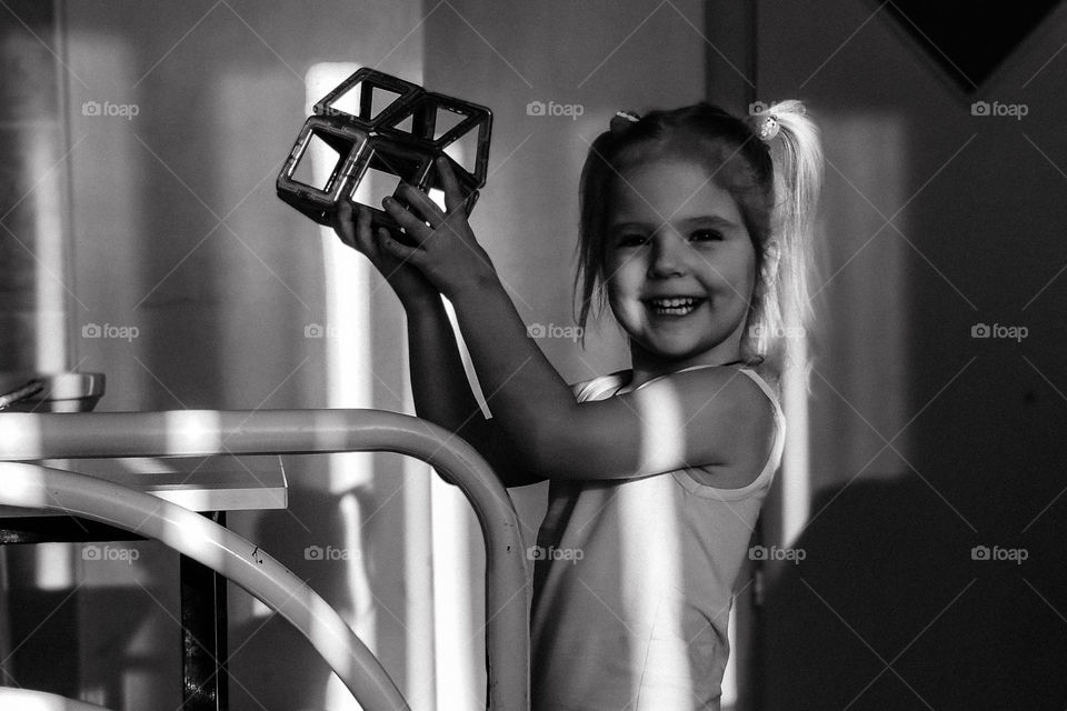 little girl with a constructor in her hands