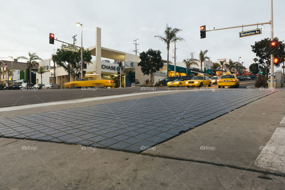 Busy intersection with yellow taxi cabs in Los Angeles in Manhattan Ave. 