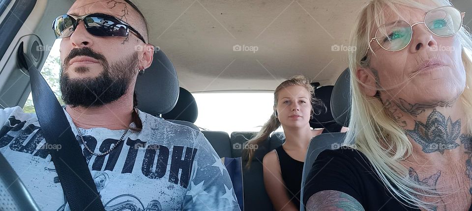 man and two women sharing a car ride