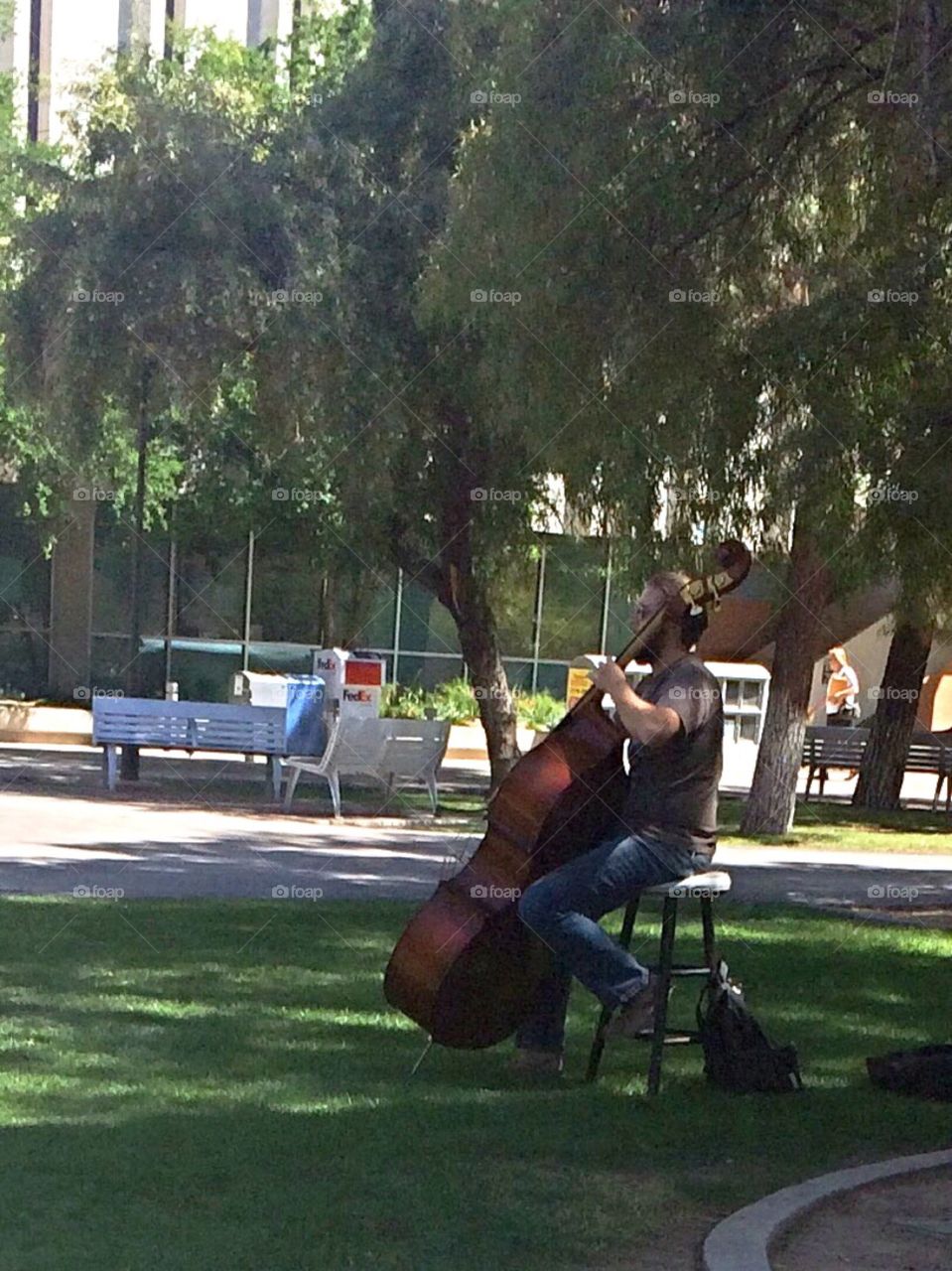 Guy playing cello on campus