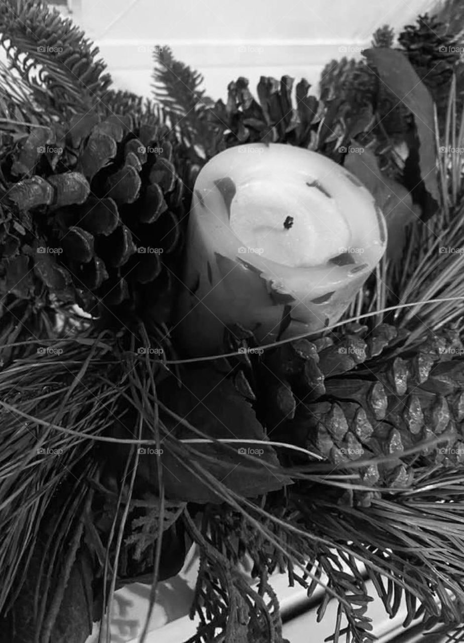 Candle in a pine cone and floral arrangement 