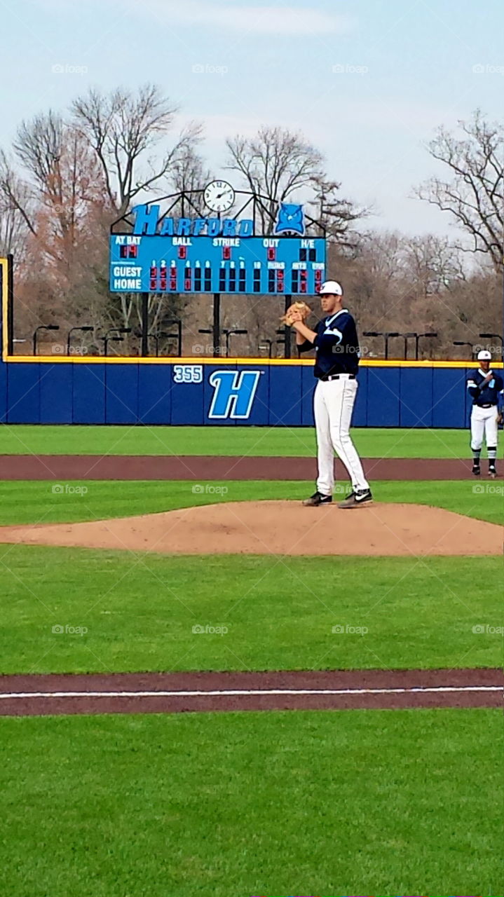 Baseball pitcher throwing the ball from the mound