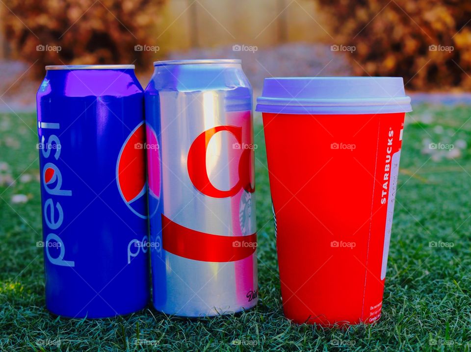 Soda cans and coffee cup come together creating the color theme for France in support of their nation
