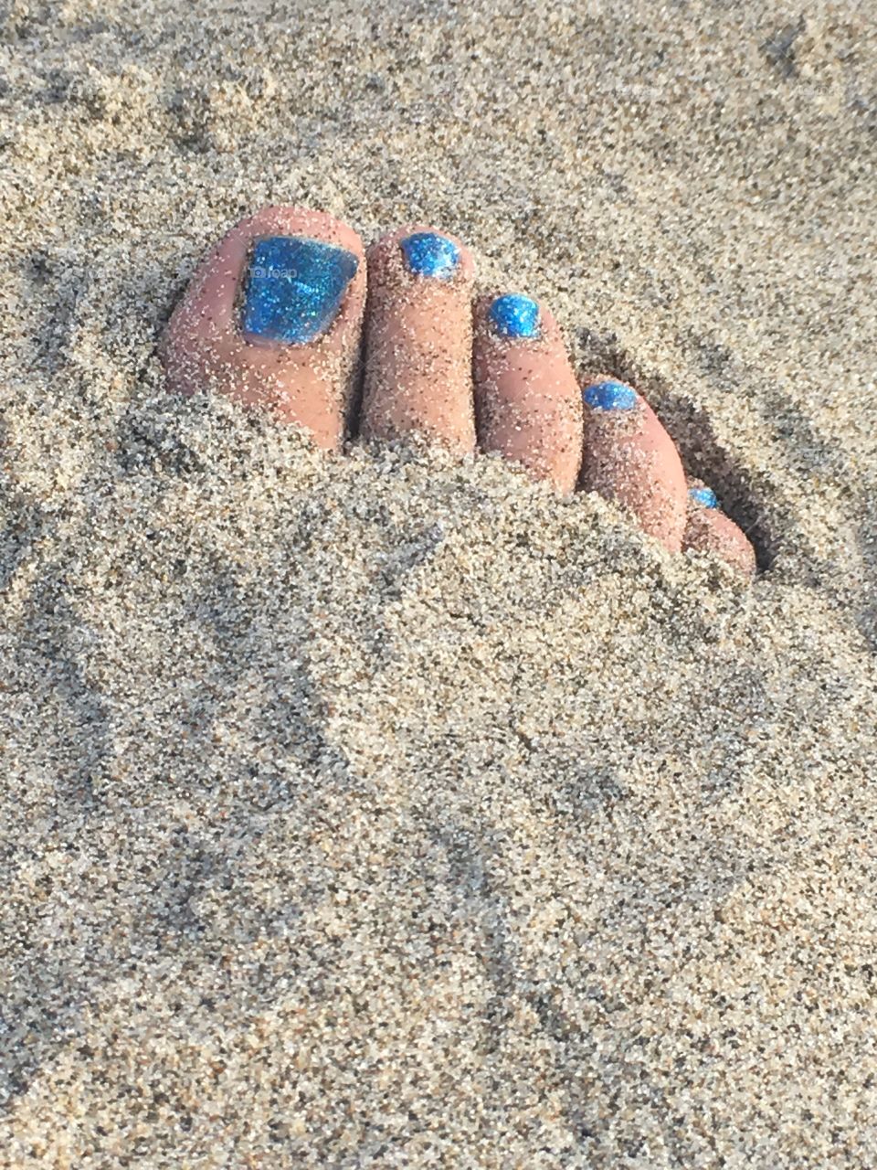 Toes buried in sand