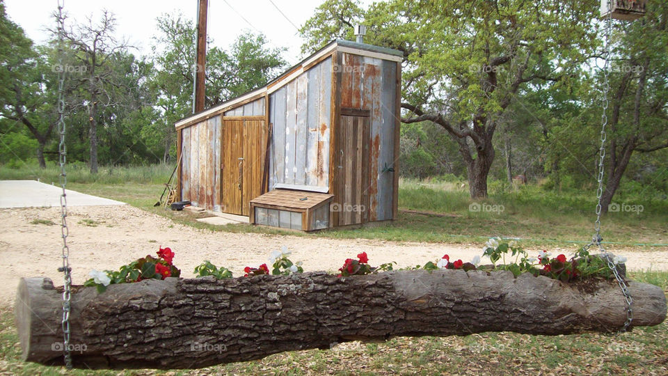 log hanging planter, not an outhouse