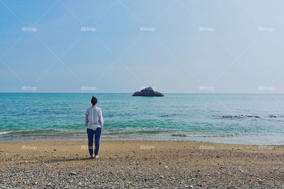 Woman walking on the sand beach 