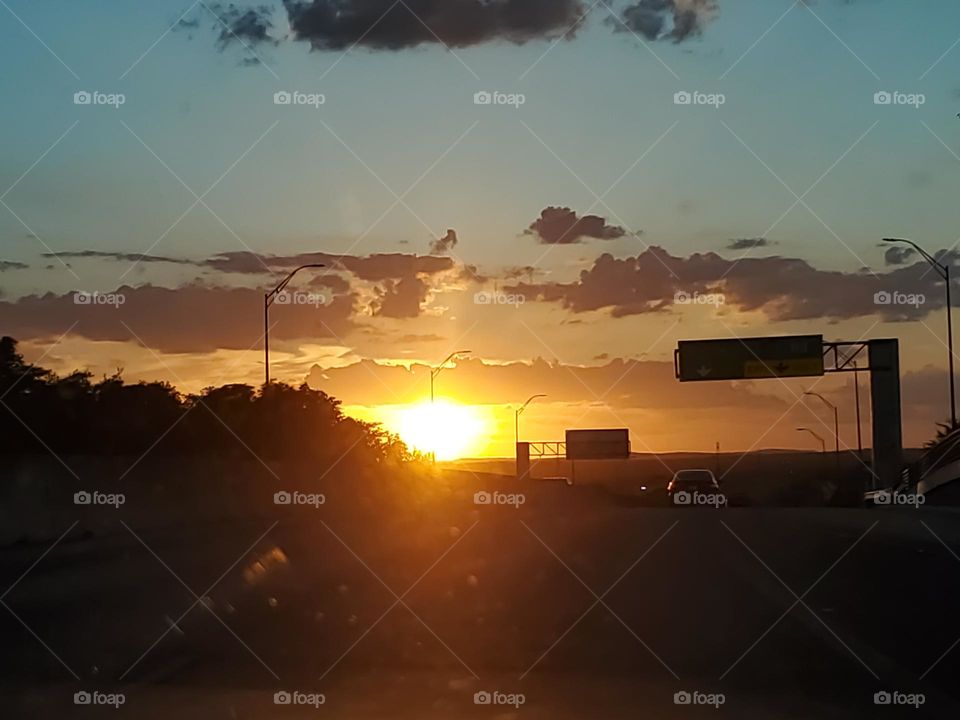 Evening commute at sunset- windshield view