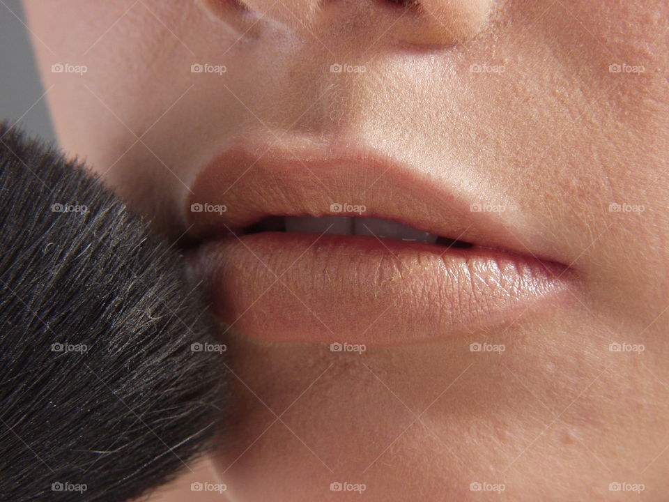 Woman makeup her lips.