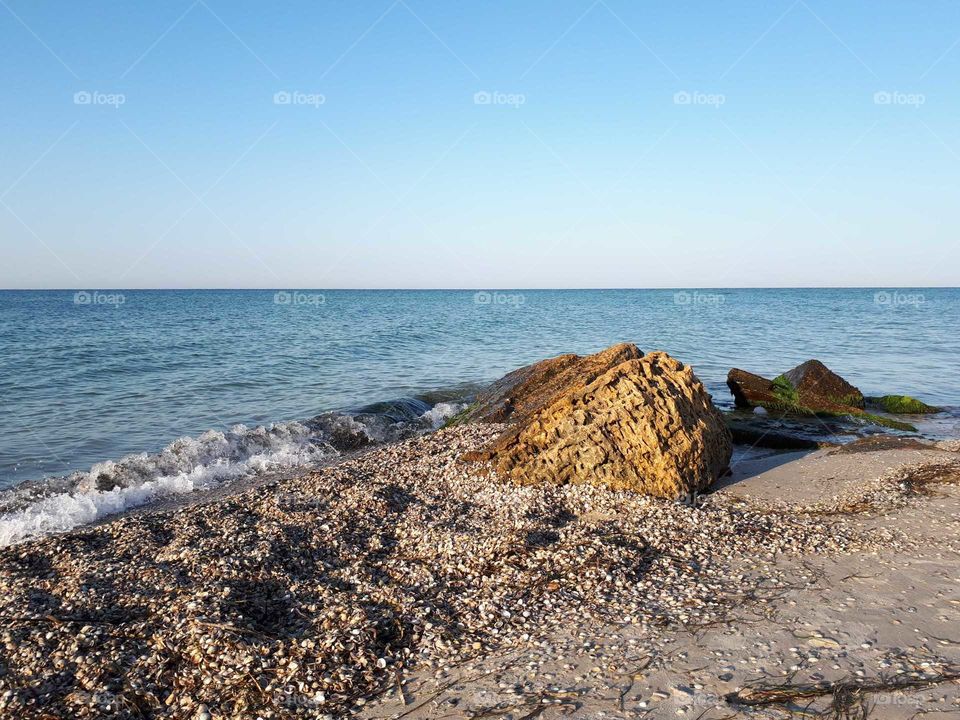 Sand beach with big rock