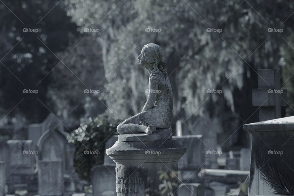 Stone Statue of Woman in Cemetery