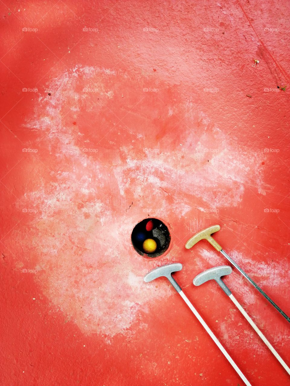 Golf set:golf balls and wedges on a red surface. Flat lay
