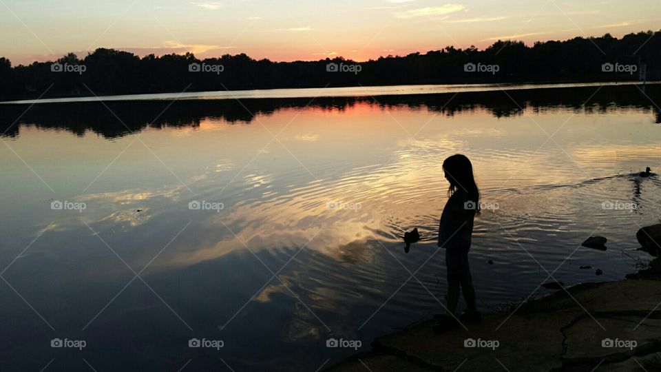 Girls silhoette watching the sunset