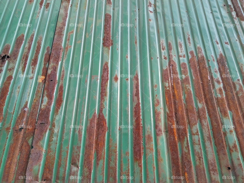 old greennzinc wall that has some rust on it surface