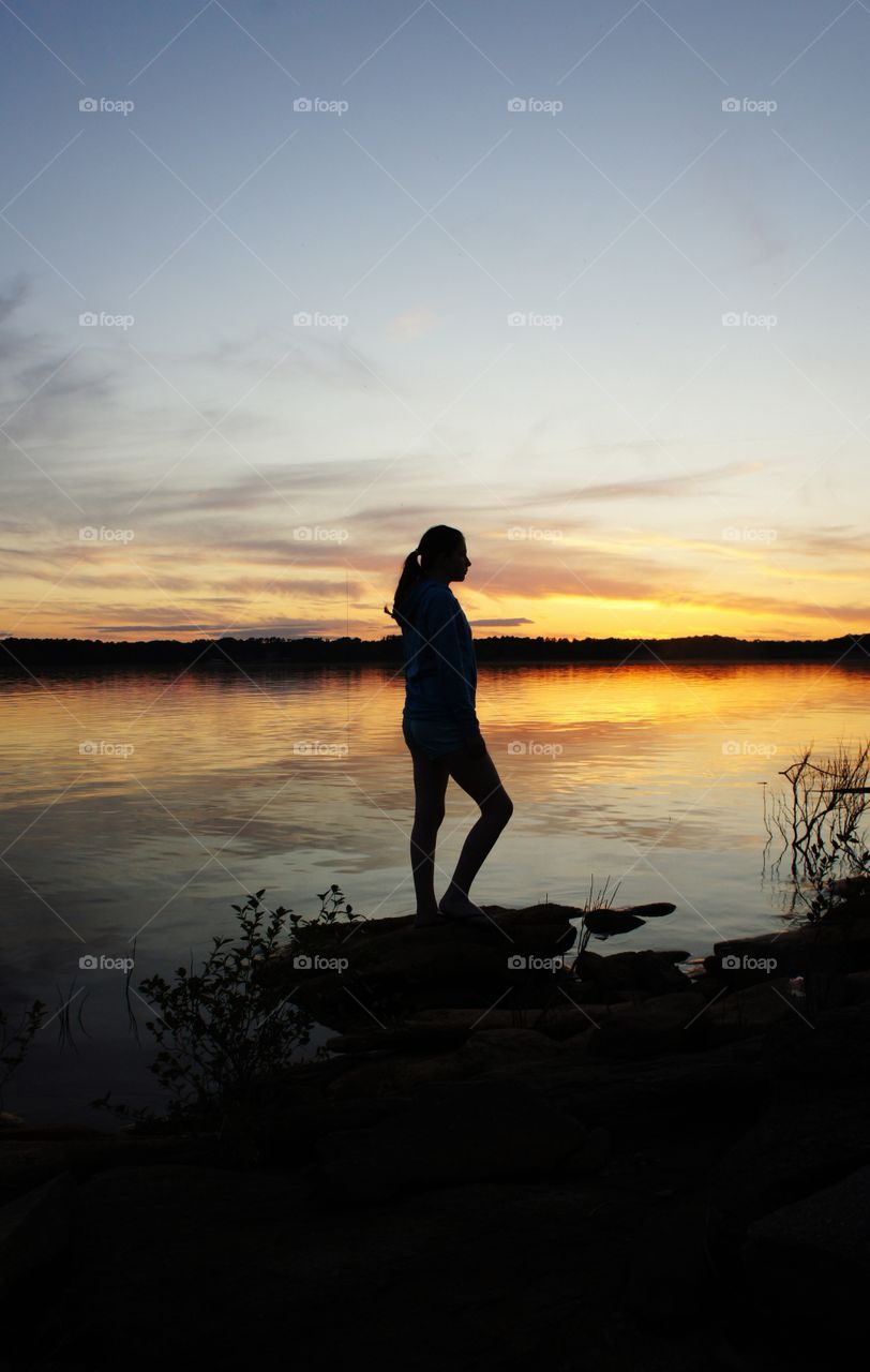 Silhouette of a girl at lakeshore