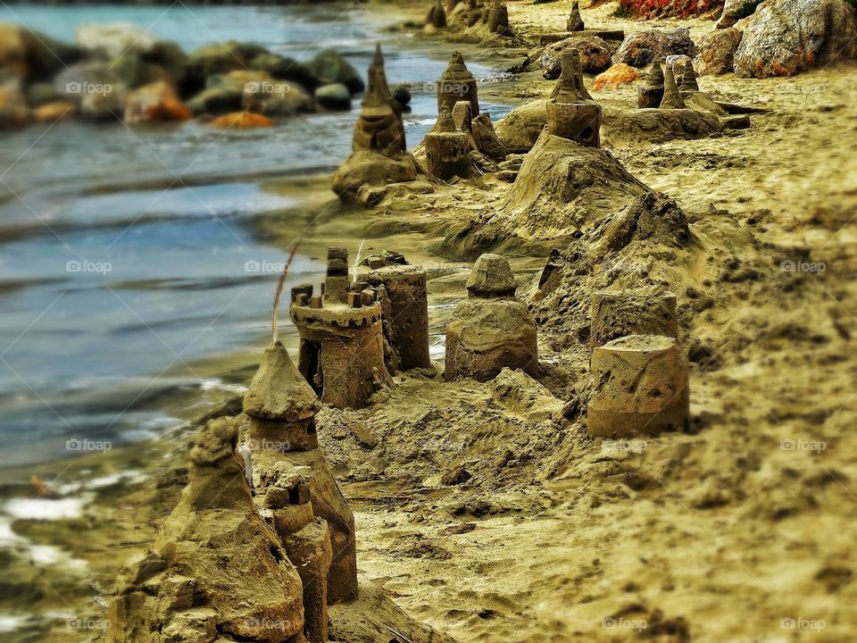 Sand Castles At Sunset. Beach Sandcastles During The Golden Hour
