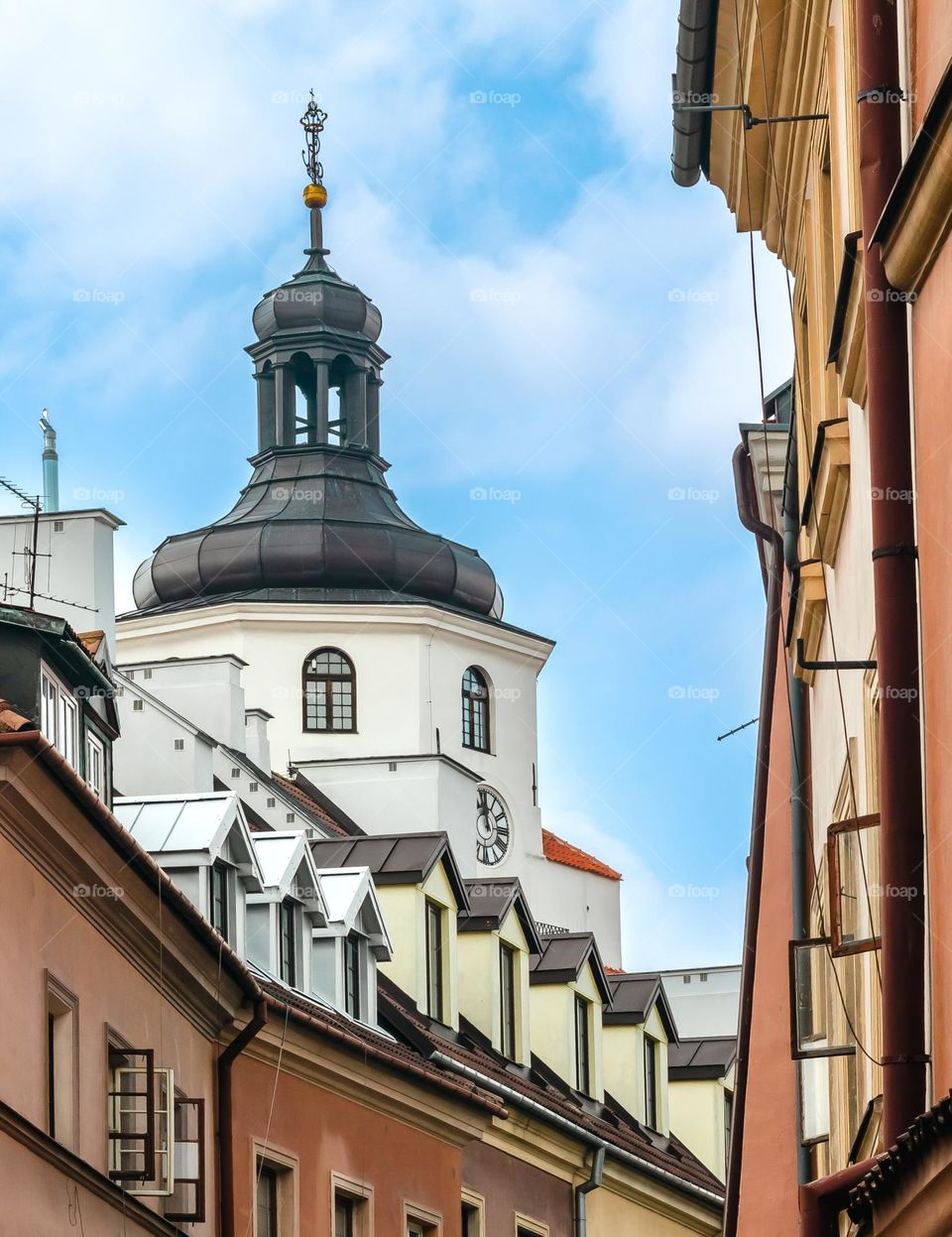 close-up of a fragment of the Krakow gate protruding from tenement houses on one of the streets of the old town