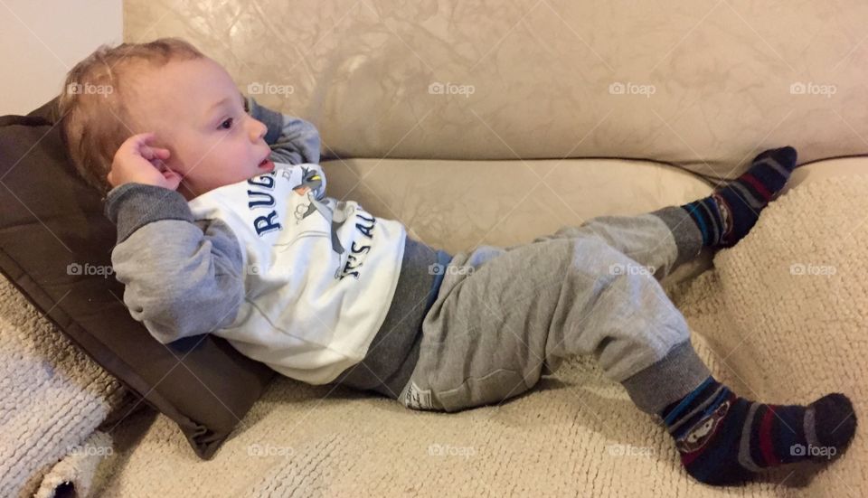 Little boy lying on sofa