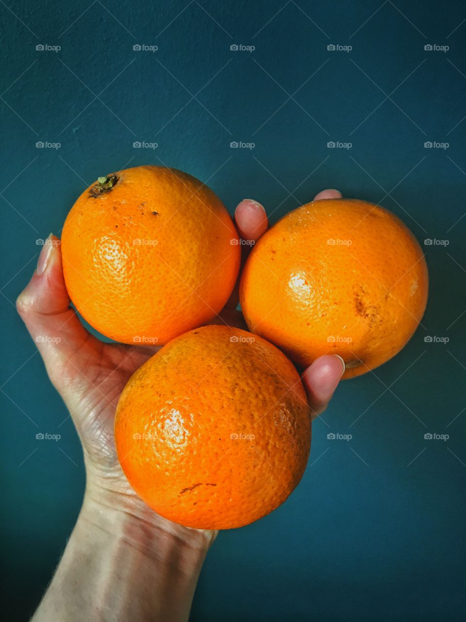 Person holding oranges