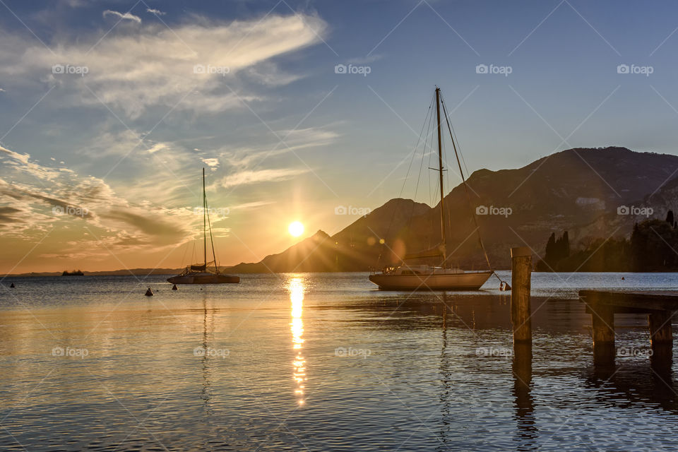 Boats at sunset. Garda lake, Italy.