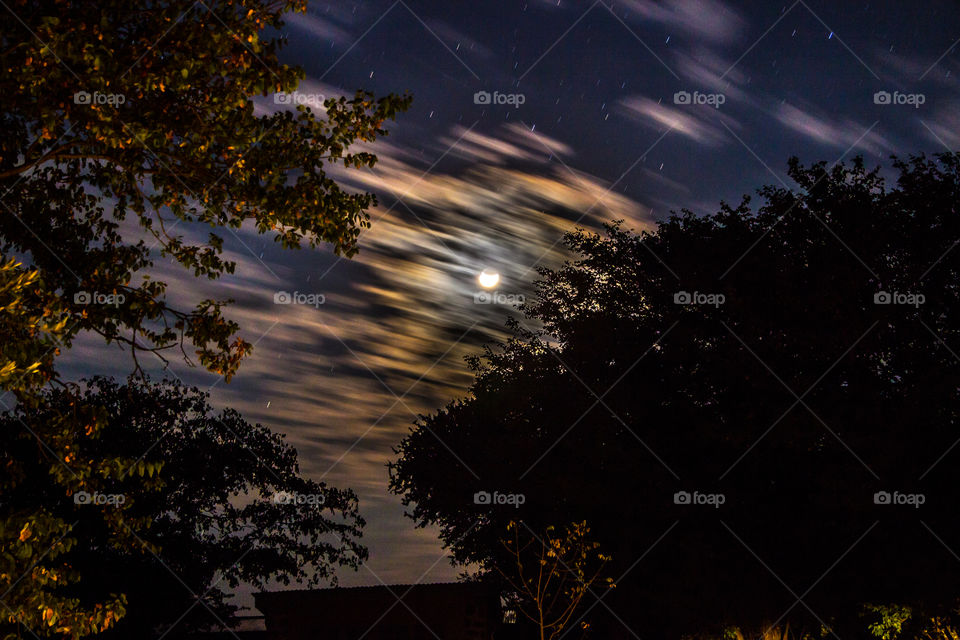 long exposure of the moon with the clouds moving