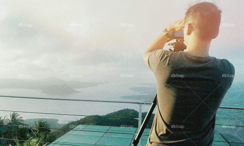 A photo of a videoman and his subject-- an active Taal volcano located in Batangas City, Philippines.