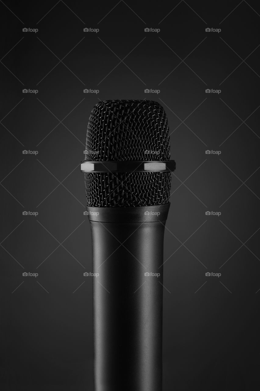 Black wireless microphone on dark background