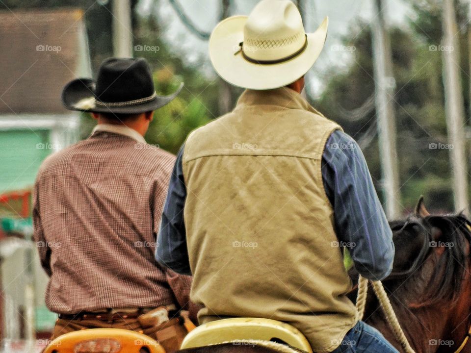 Modern Cowboys. Two Men In Cowboy Hats On Horseback
