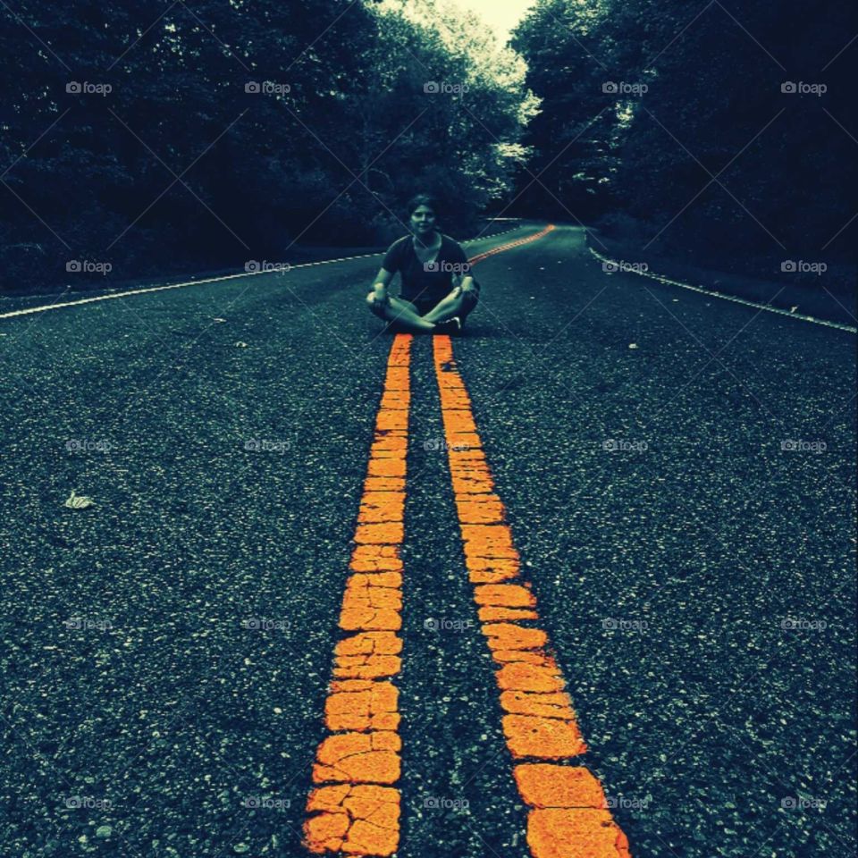 women sitting in road