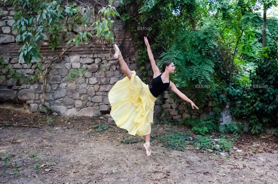 Young Female Ballerina Dancing Outside in Nature