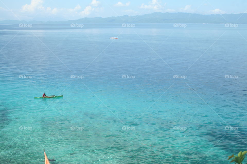 Boat man at the beautiful turquoise sea waters