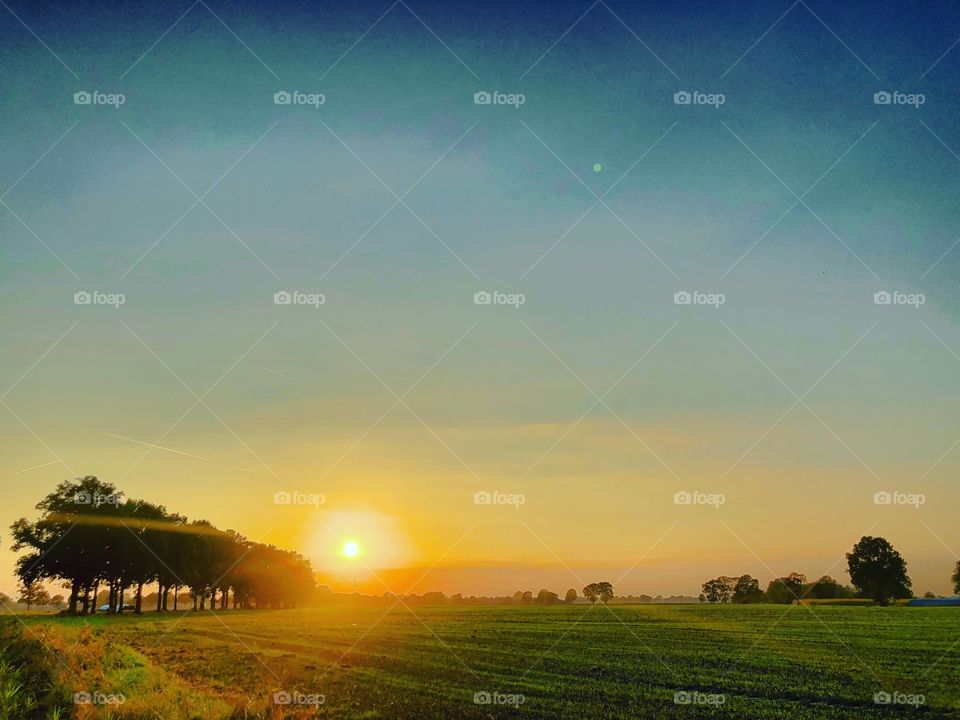 Beautiful idyllic Countryside sunrise landscape taken during the Golden hour in the summer